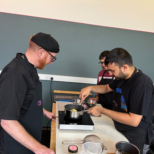 man holding a tray of red heart-shaped chocolates in a kitchen 8 assorted sweets cute treats